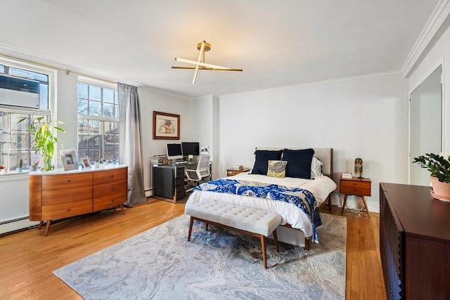 bedroom featuring crown molding, a baseboard radiator, wood-type flooring, and a wall mounted air conditioner