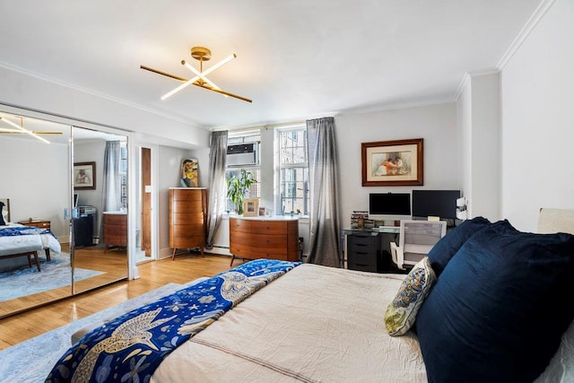 bedroom featuring crown molding, hardwood / wood-style flooring, a wall unit AC, and baseboard heating