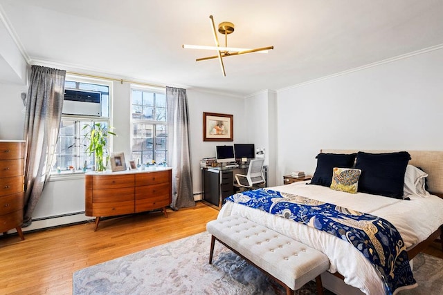 bedroom with crown molding, light hardwood / wood-style floors, and baseboard heating