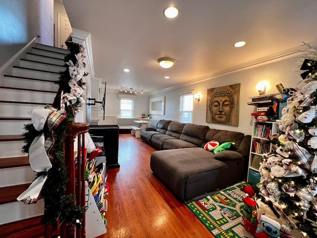 living room with hardwood / wood-style floors and crown molding