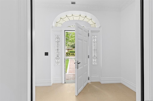 entrance foyer featuring crown molding