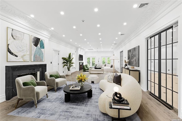 living room with crown molding and hardwood / wood-style flooring