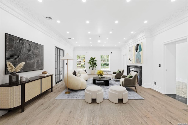 living room featuring ornamental molding and light hardwood / wood-style floors