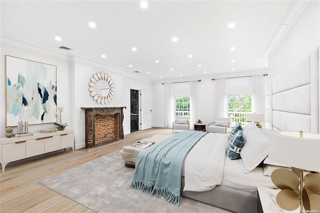 bedroom with crown molding and light wood-type flooring