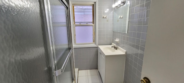 bathroom featuring vanity, tile patterned floors, and tile walls