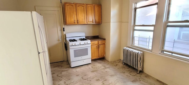 kitchen with plenty of natural light, white appliances, and radiator heating unit