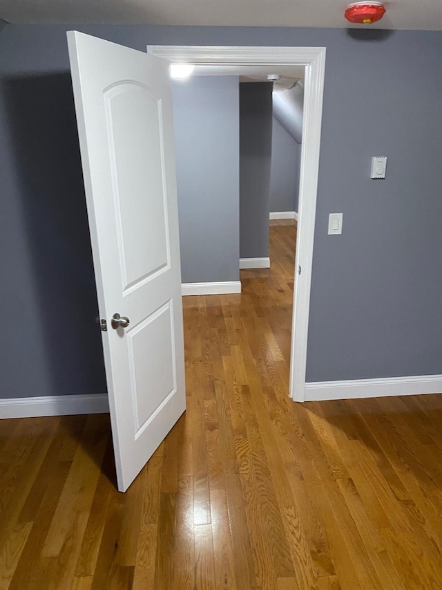 corridor with light hardwood / wood-style floors