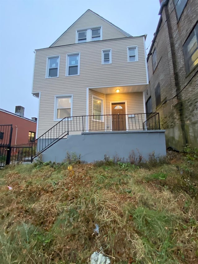 back of house featuring a porch