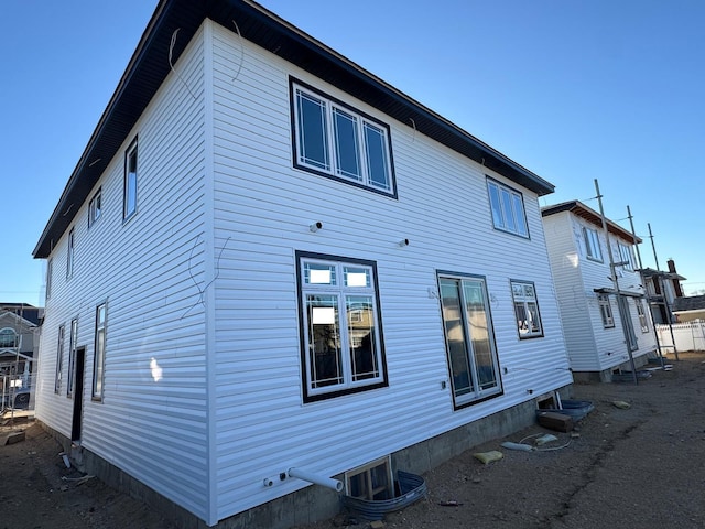 back of house with central AC unit