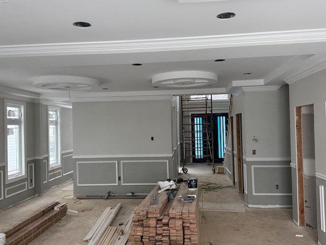 interior space featuring a tray ceiling and ornamental molding