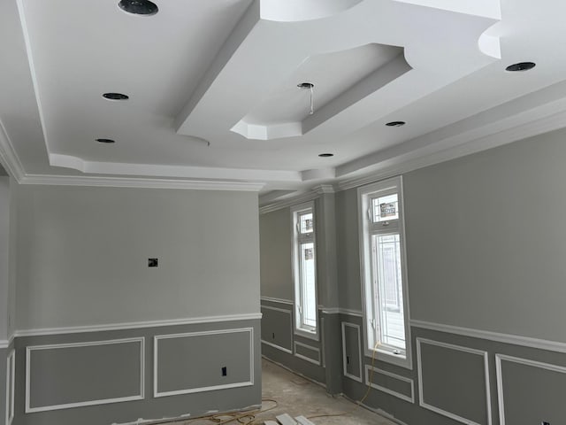 foyer with ornamental molding and a tray ceiling