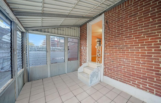 unfurnished sunroom featuring lofted ceiling