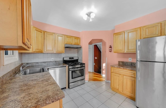 kitchen with decorative backsplash, light brown cabinets, sink, and appliances with stainless steel finishes