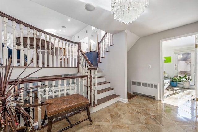 stairs with radiator heating unit and a notable chandelier