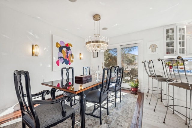 dining room featuring an inviting chandelier and light wood-type flooring