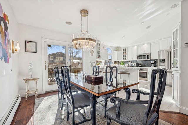 dining room featuring a baseboard radiator, lofted ceiling, dark hardwood / wood-style flooring, and a wealth of natural light