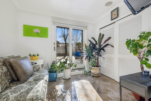 living area featuring crown molding