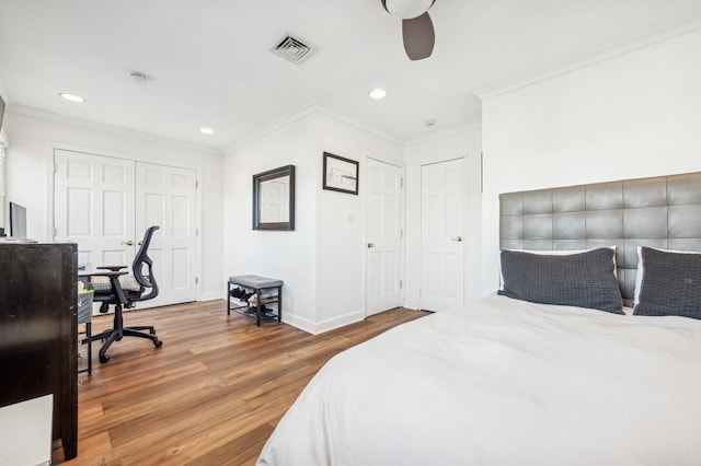 bedroom with crown molding, wood-type flooring, and ceiling fan