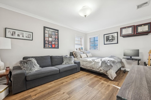 bedroom featuring ornamental molding and light hardwood / wood-style floors