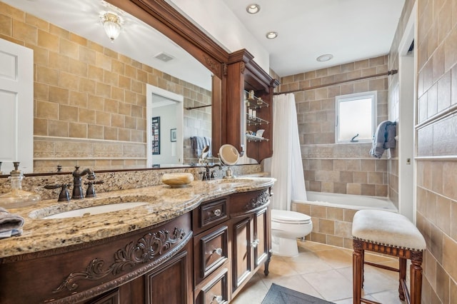 full bathroom featuring toilet, shower / tub combo, tile walls, vanity, and tile patterned flooring