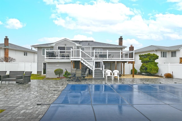 rear view of house with a patio area and a pool side deck