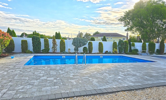 view of swimming pool with a patio area