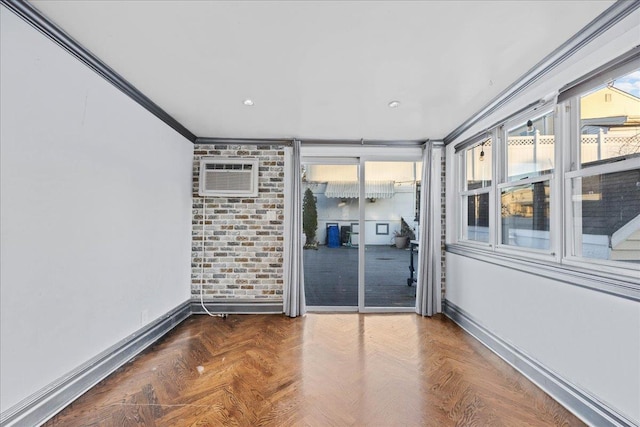 unfurnished room with dark parquet floors, ornamental molding, and an AC wall unit