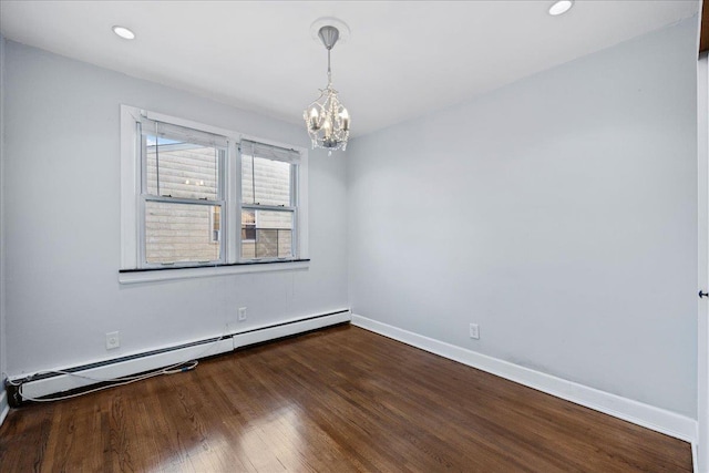 unfurnished room featuring a chandelier, dark hardwood / wood-style flooring, and a baseboard heating unit