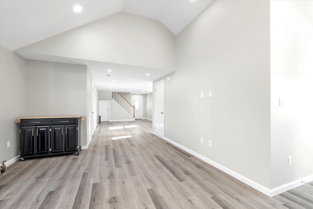 interior space featuring lofted ceiling and light wood-type flooring