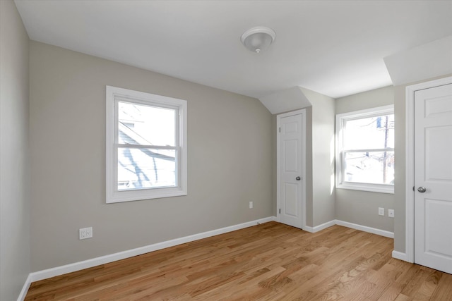 bonus room with a healthy amount of sunlight and light wood-type flooring