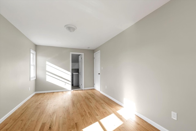 unfurnished room with light wood-type flooring