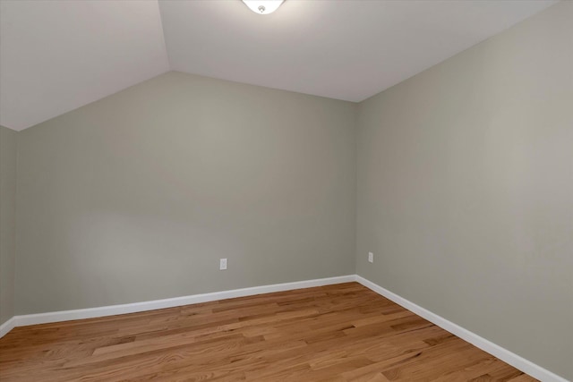 additional living space featuring light hardwood / wood-style floors and vaulted ceiling