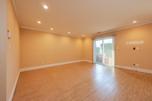 unfurnished room with crown molding and light hardwood / wood-style floors