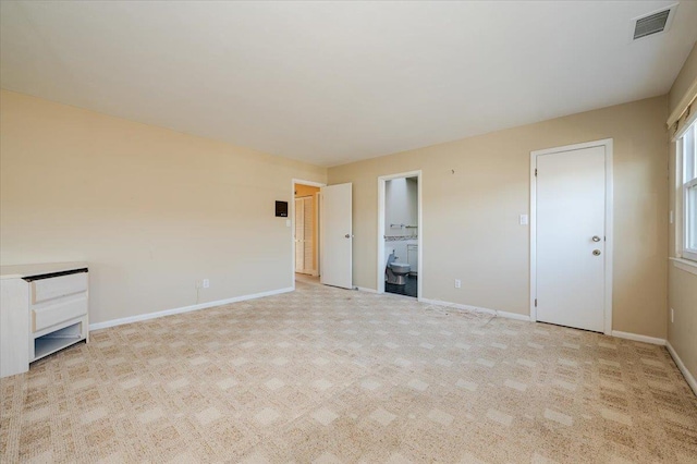 unfurnished bedroom with light colored carpet and ensuite bath