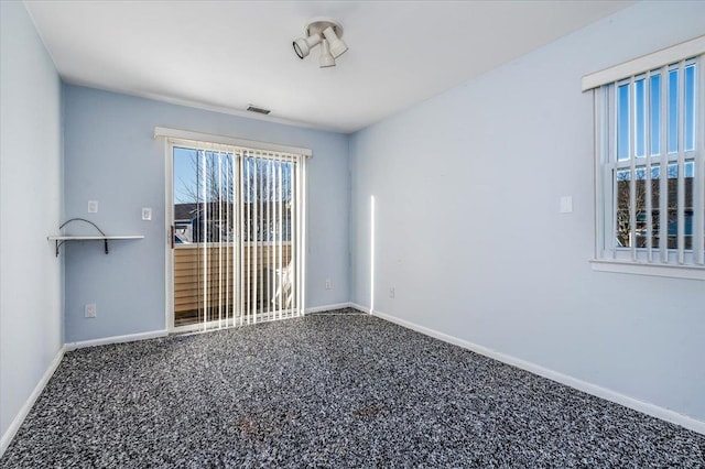 unfurnished room featuring carpet and plenty of natural light