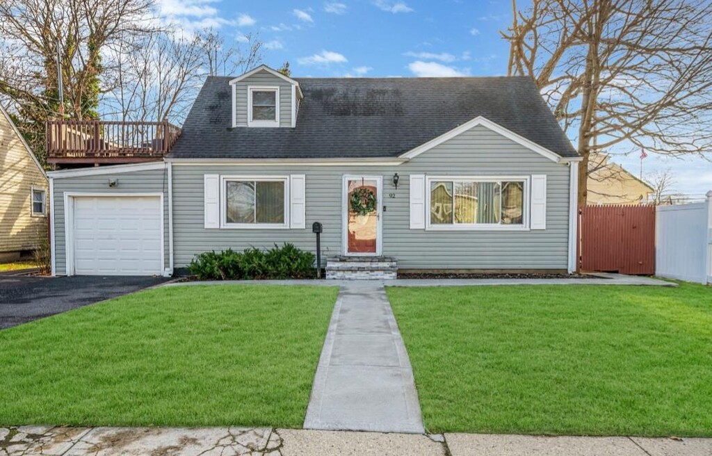 new england style home with a front lawn