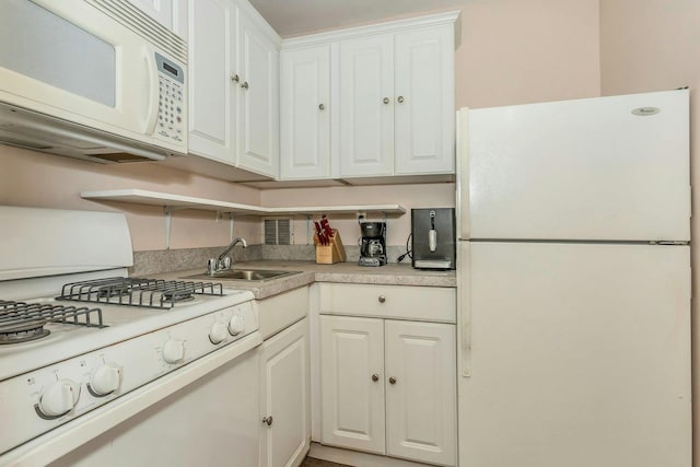 kitchen featuring white cabinetry, sink, and white appliances