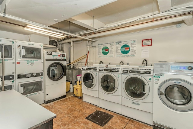 laundry room with light tile patterned floors, washer and dryer, and stacked washer / drying machine