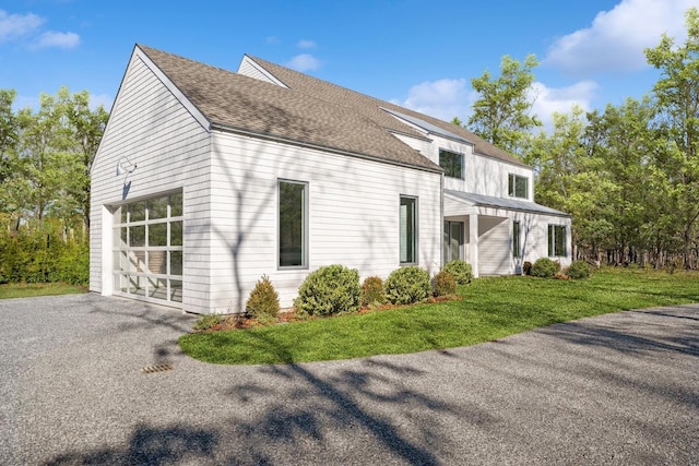 view of property exterior with a yard and a garage