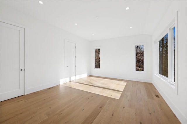 spare room with a wealth of natural light and light wood-type flooring