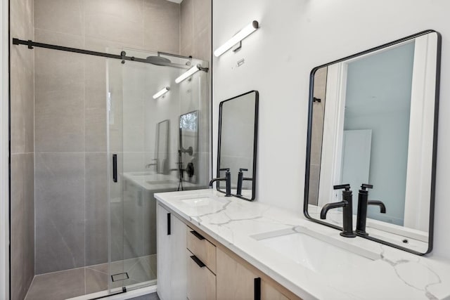 bathroom featuring vanity and a shower with shower door