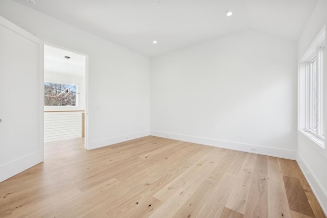 empty room featuring light hardwood / wood-style floors and lofted ceiling