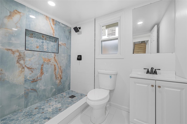 bathroom with tiled shower, vanity, toilet, and crown molding