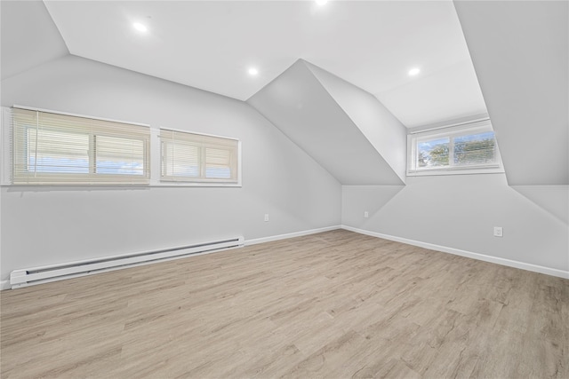 bonus room with a baseboard radiator, vaulted ceiling, and light hardwood / wood-style floors