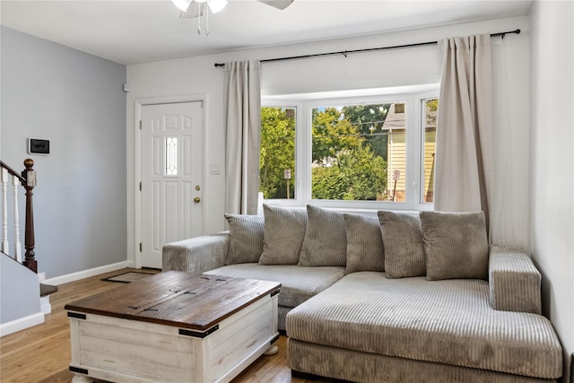 living room featuring light wood-type flooring and ceiling fan