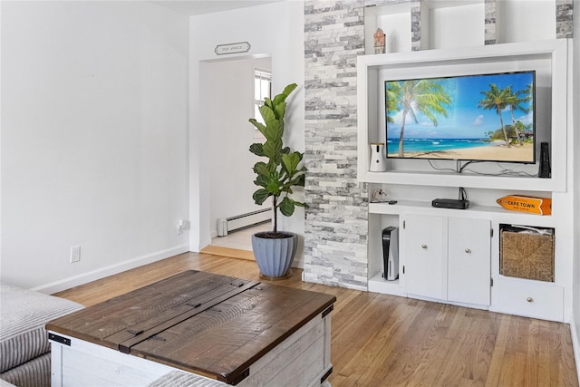 living room with light wood-type flooring and a baseboard radiator