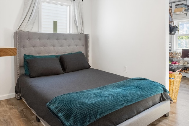 bedroom with hardwood / wood-style flooring