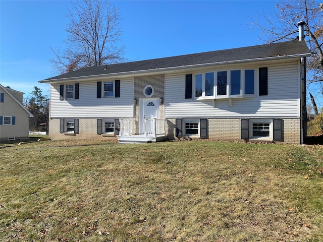 raised ranch with a front yard