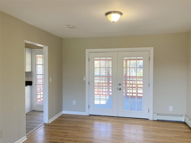 entryway with french doors and light hardwood / wood-style flooring