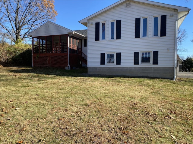 view of property exterior with a sunroom and a yard